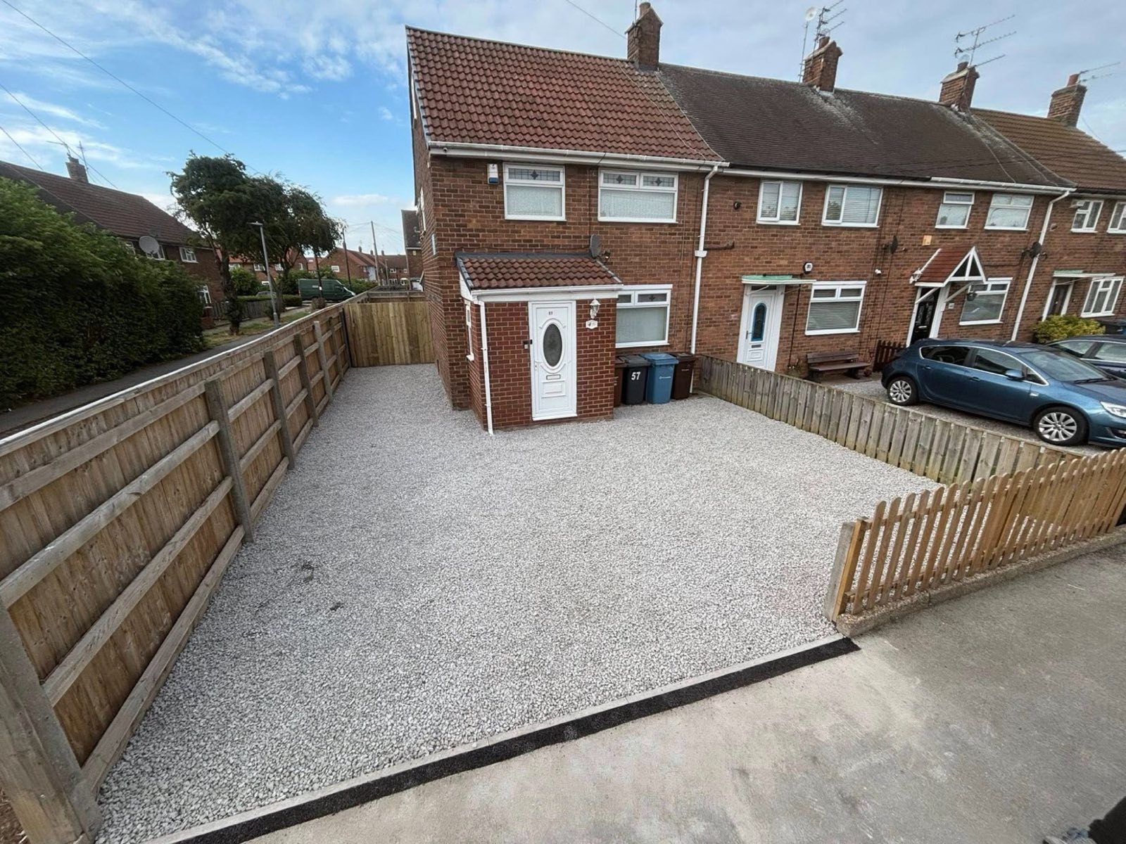 Gravel driveway with new fence panels