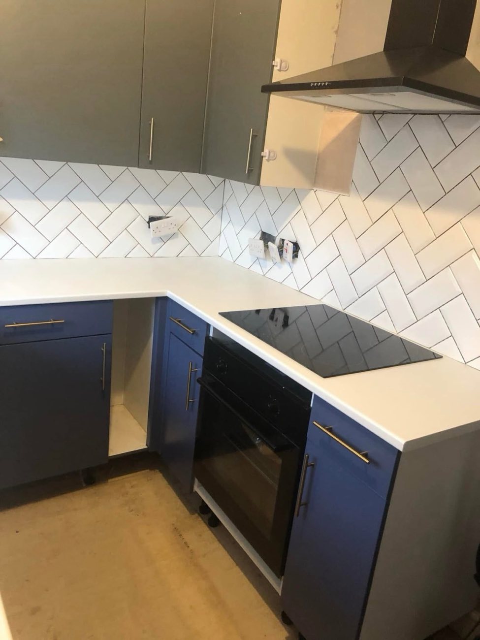 Navy kitchen with herringbone metro tiles