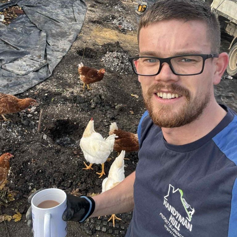 Luke, founder of Handyman Hull, with a brew and his chickens