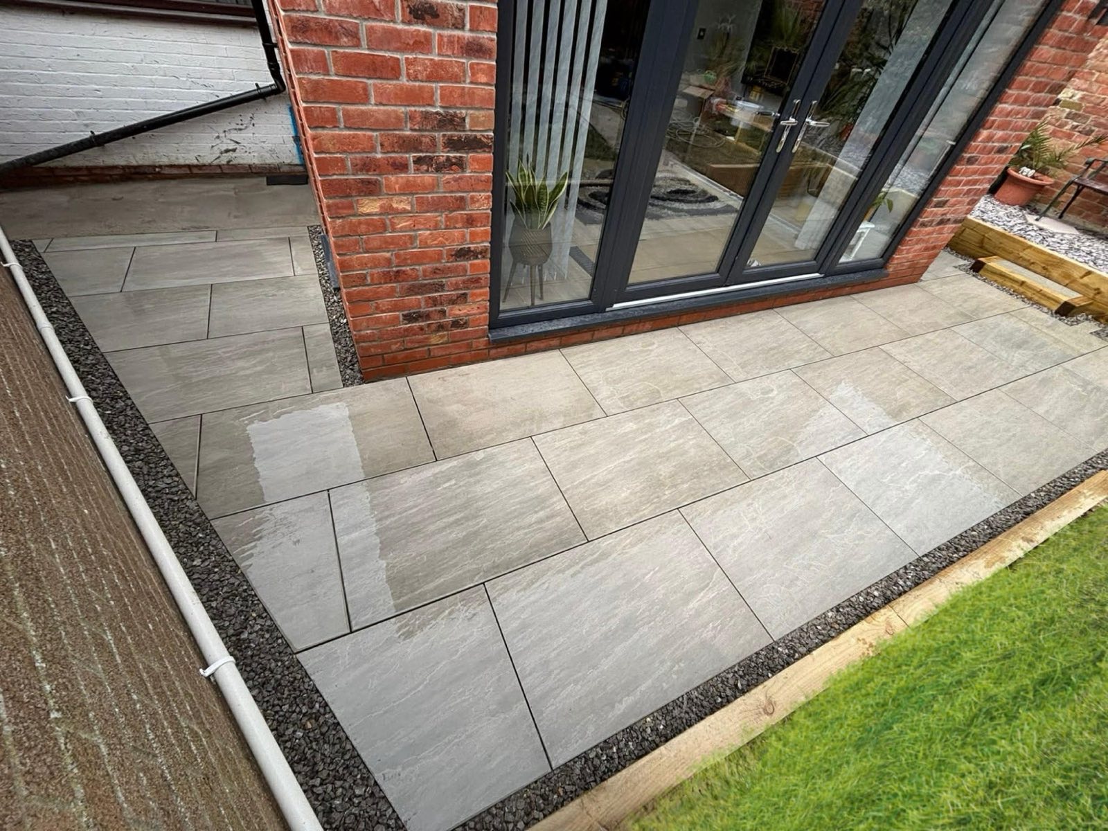 Grey porcelain patio laid beside bi-fold doors